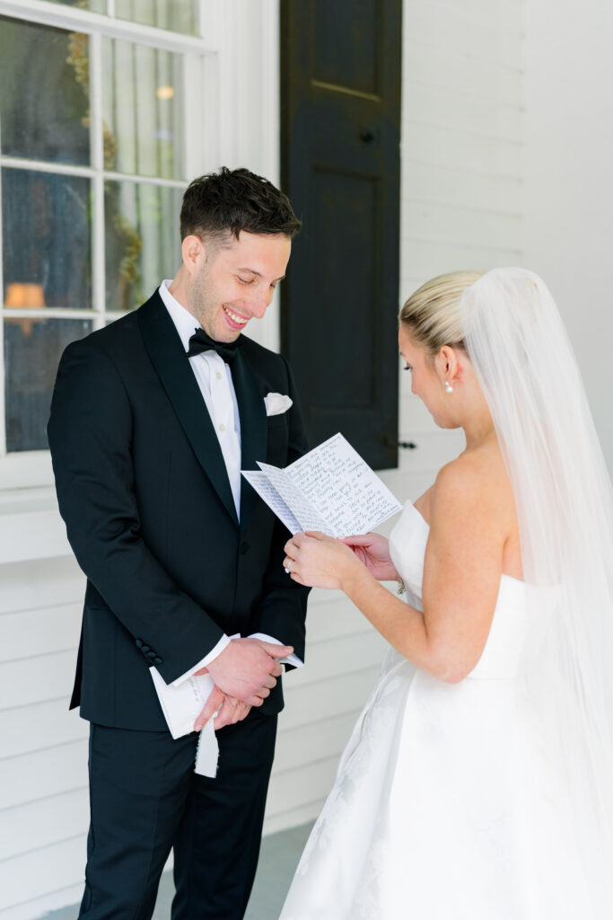 Bride and groom private vow reading on the porch at Thomas Bennett House. 