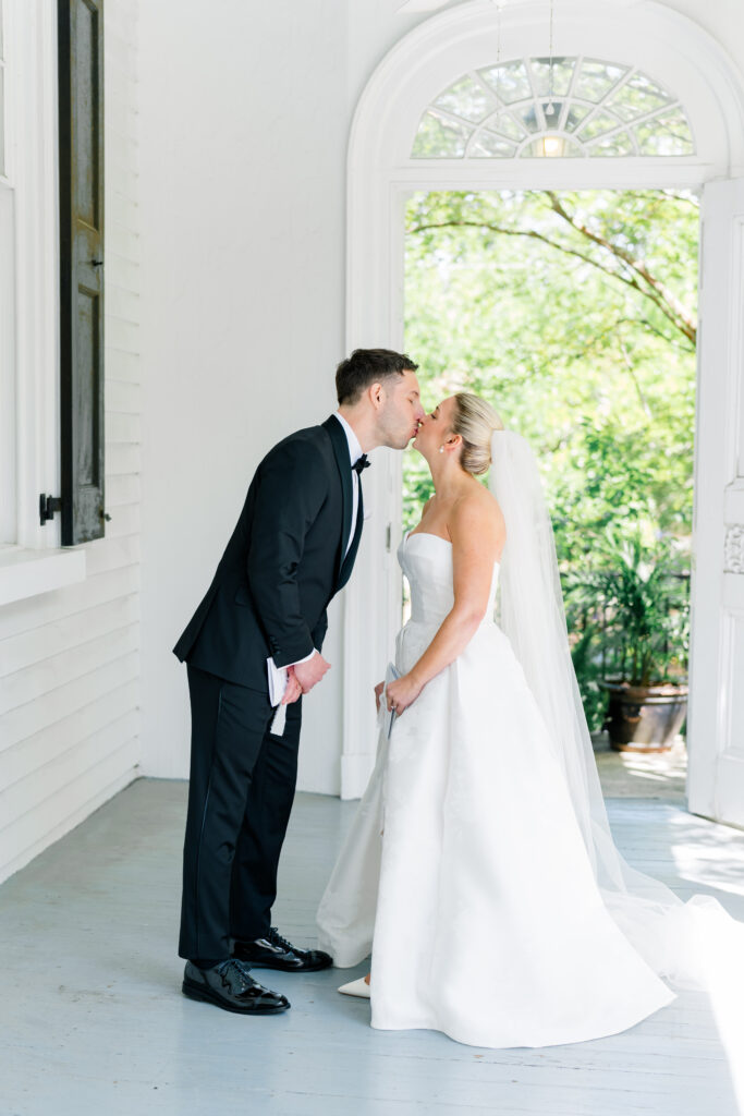 Bride and groom kiss after private vow reading. 