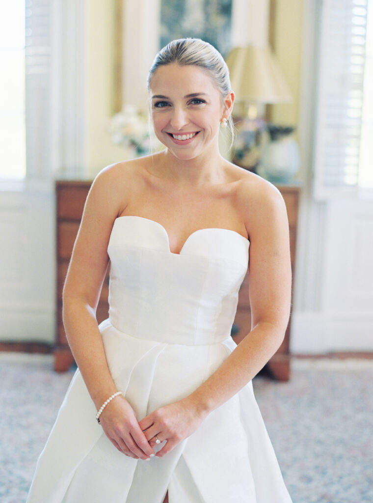 Film photo of bride smiling for the camera in yellow room at Thomas Bennett House spring wedding. 