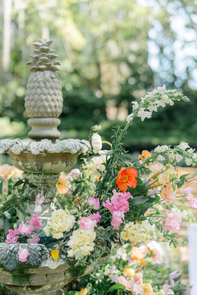 Pineapple fountain decorating in spring flowers in the garden at Thomas Bennett House. 