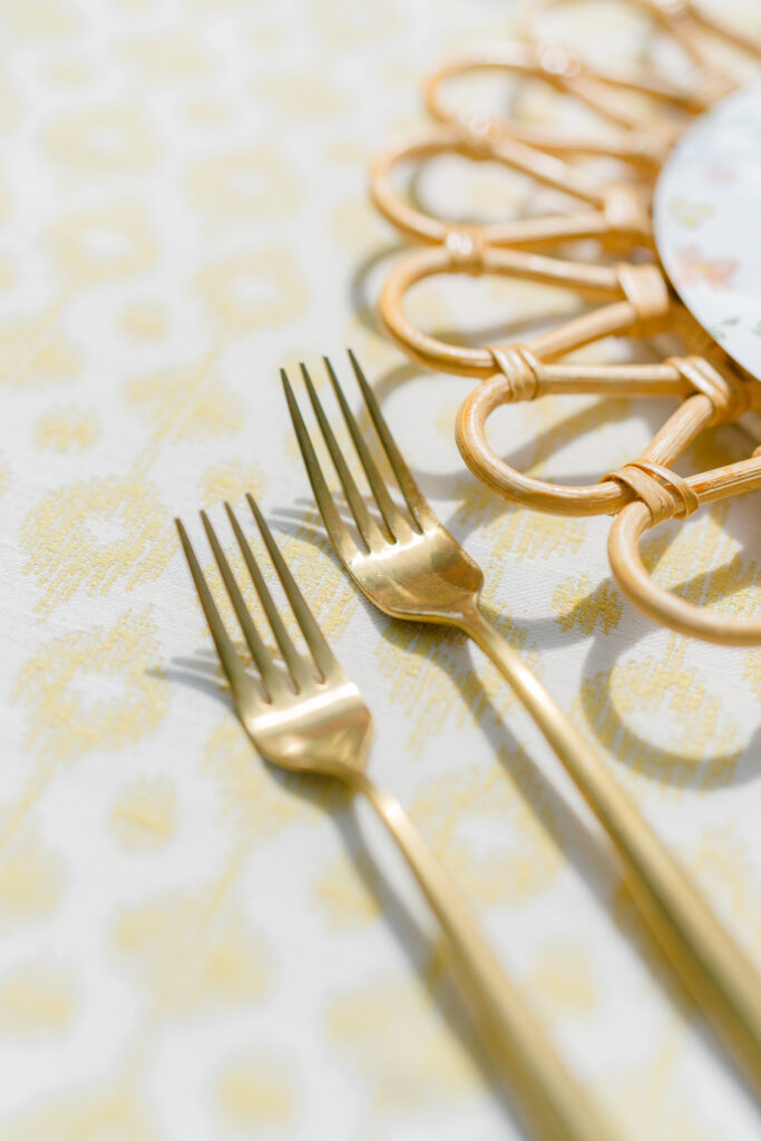 Wedding reception detail of gold utensils. Garden party spring destination wedding.