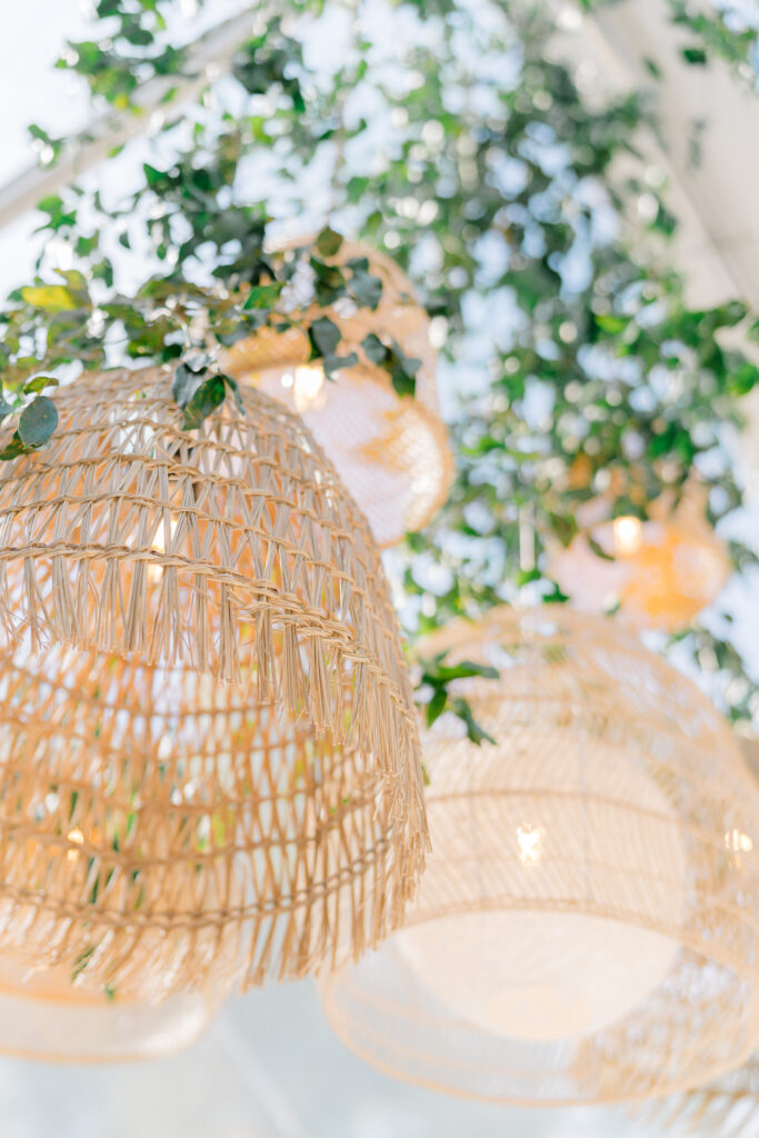 Mix-matched wicker lanterns and greenery. Perfect spring statement piece for outdoor wedding reception. 