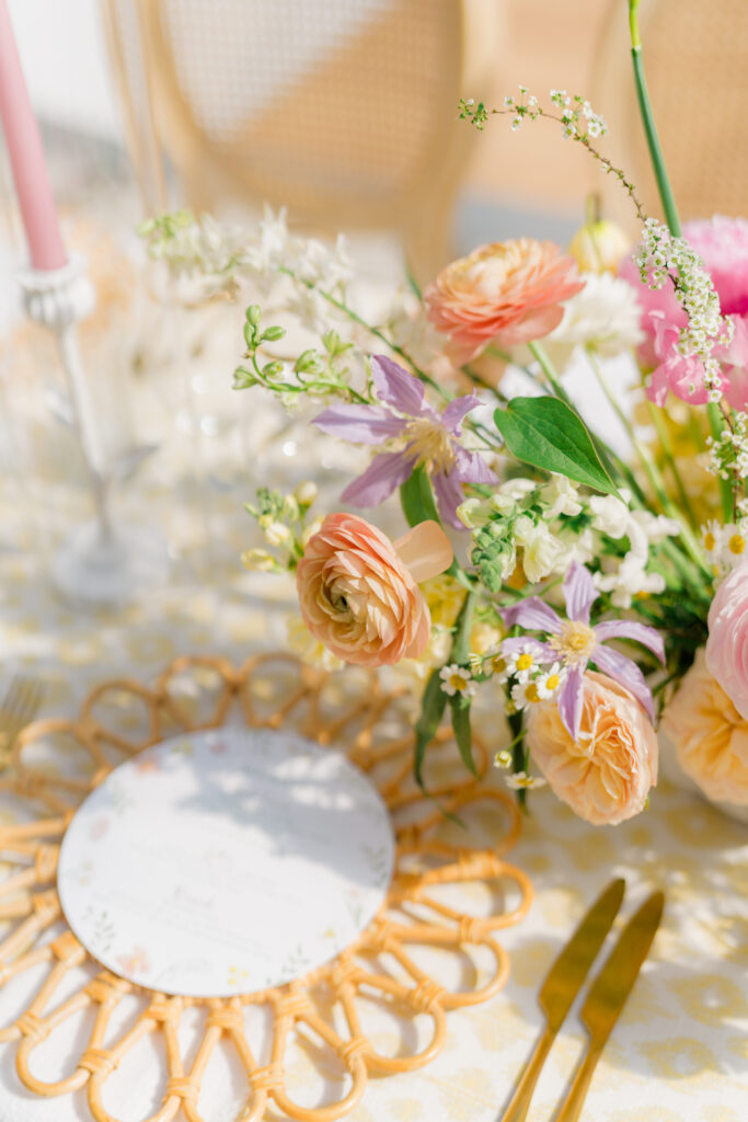 Peach and purple wedding reception flowers. 