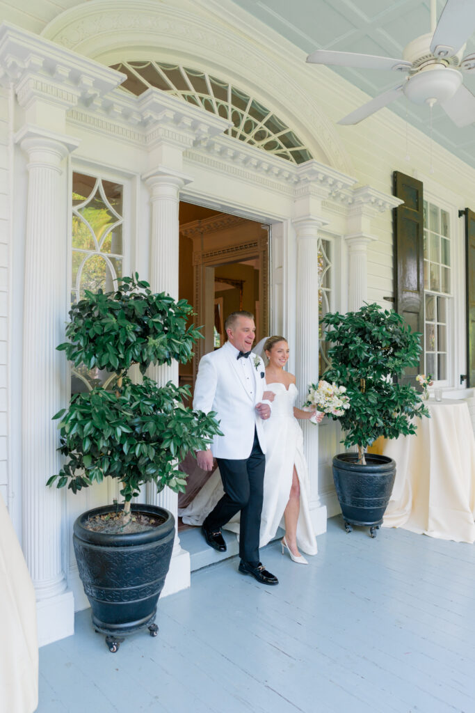 Thomas Bennett House wedding ceremony. Bride and her dad walk out of the door to their guests. 