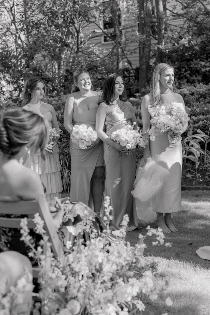 Bridesmaids standing in the sun. 