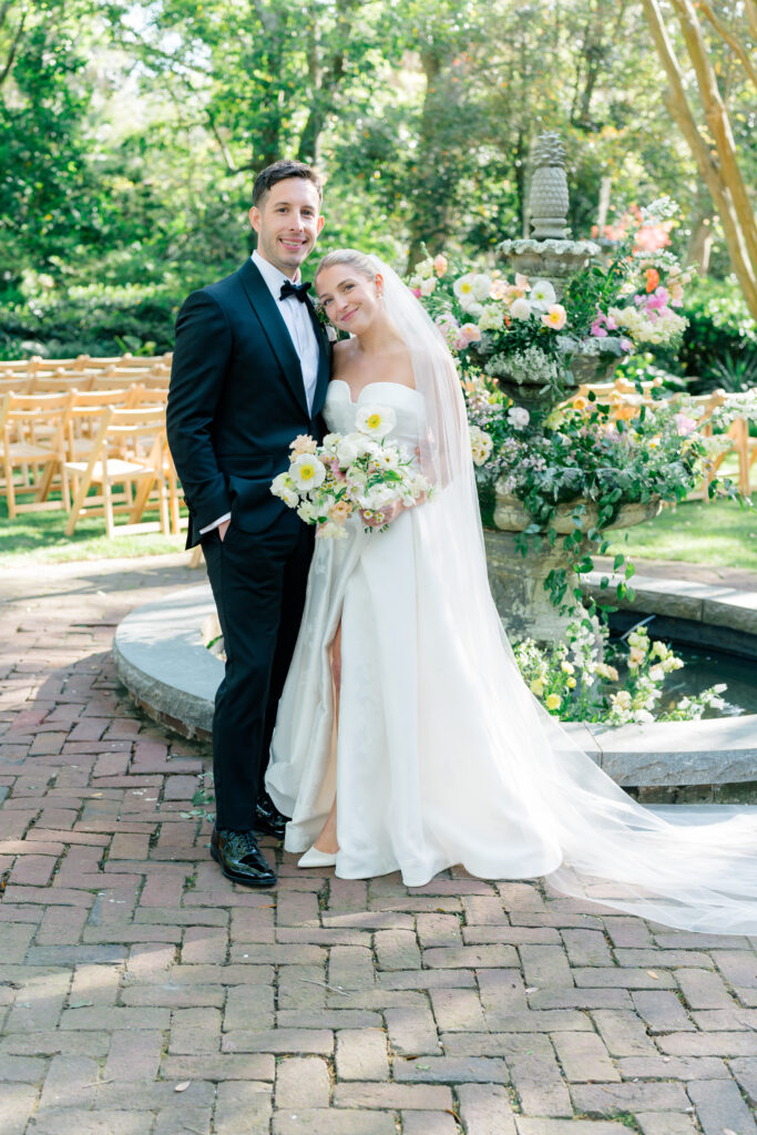 Bride and groom in front of the fountain at Governor Thomas Bennett House. Charleston wedding photographer. 