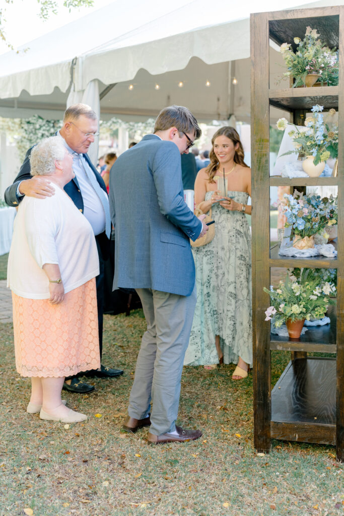 Wedding guests arrive and find their seats. 