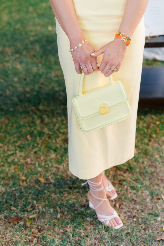 Yellow monochrome wedding rehearsal dinner outfit. Matching purse and dress. 