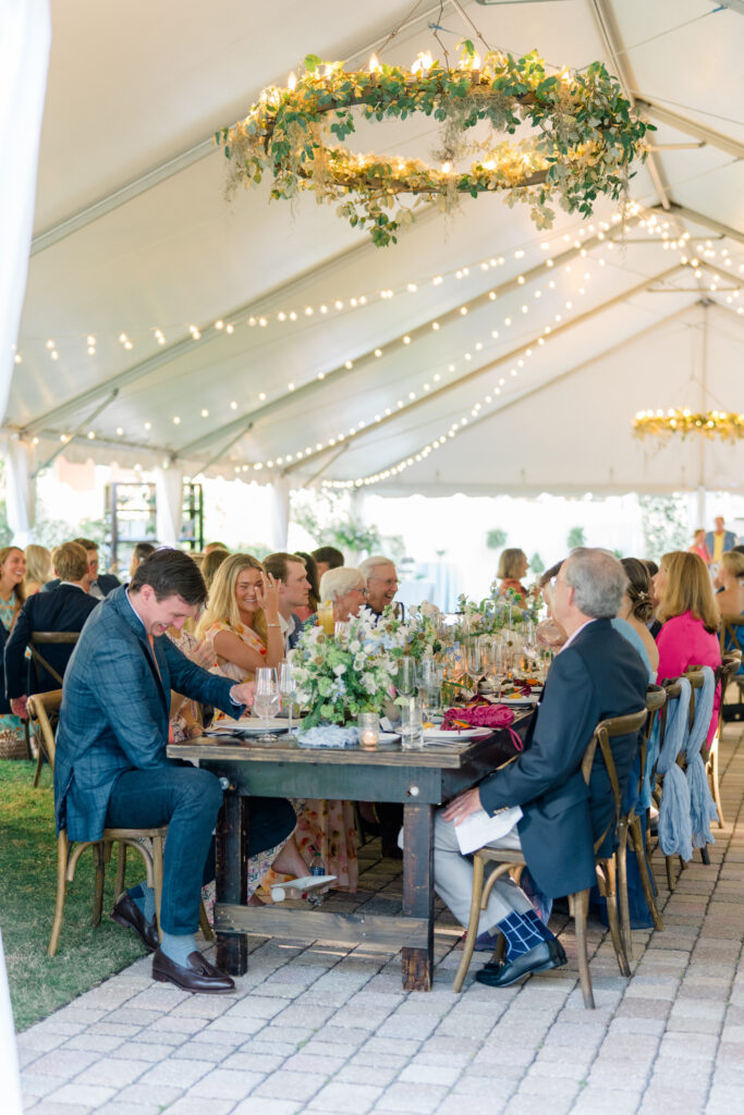 Laughter erupts at the head table during dinner at the Beaufort Inn. Destination wedding photographer. 