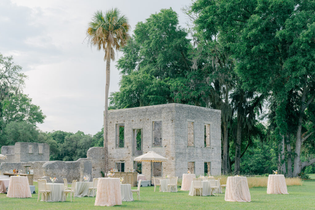 Cocktail hour on the lawn at Old Tabby Links. Palm tree and old building. 