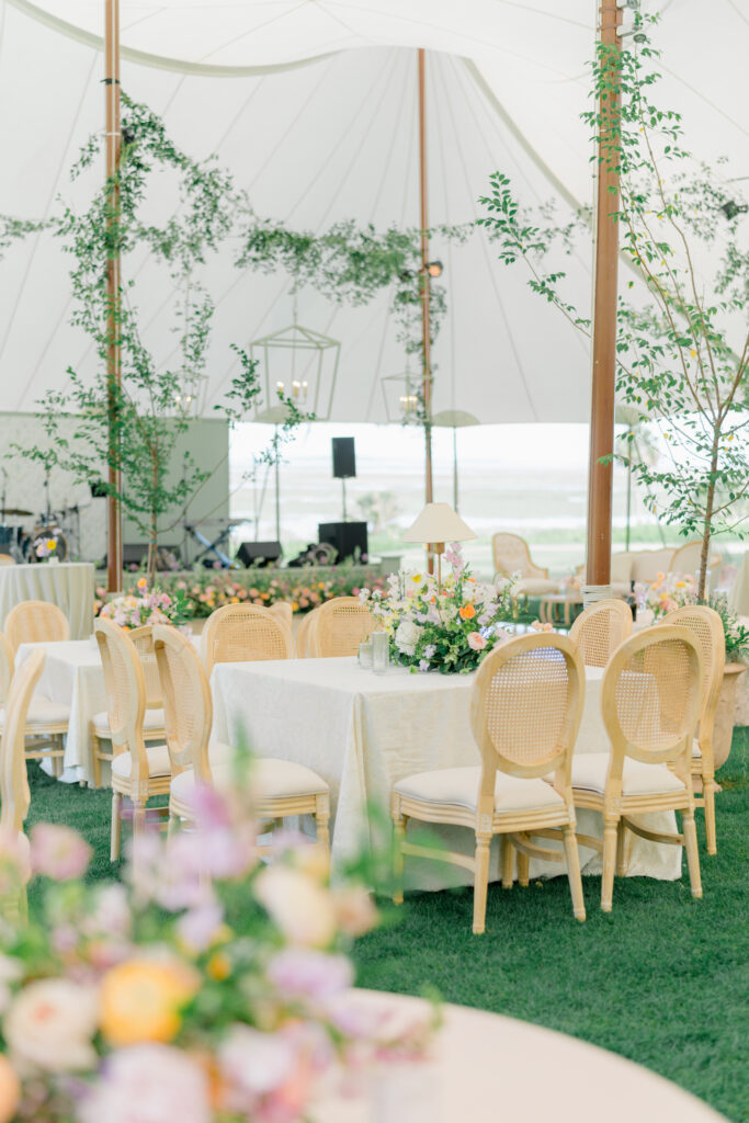 Wedding reception tent with greenery and spring flowers. 