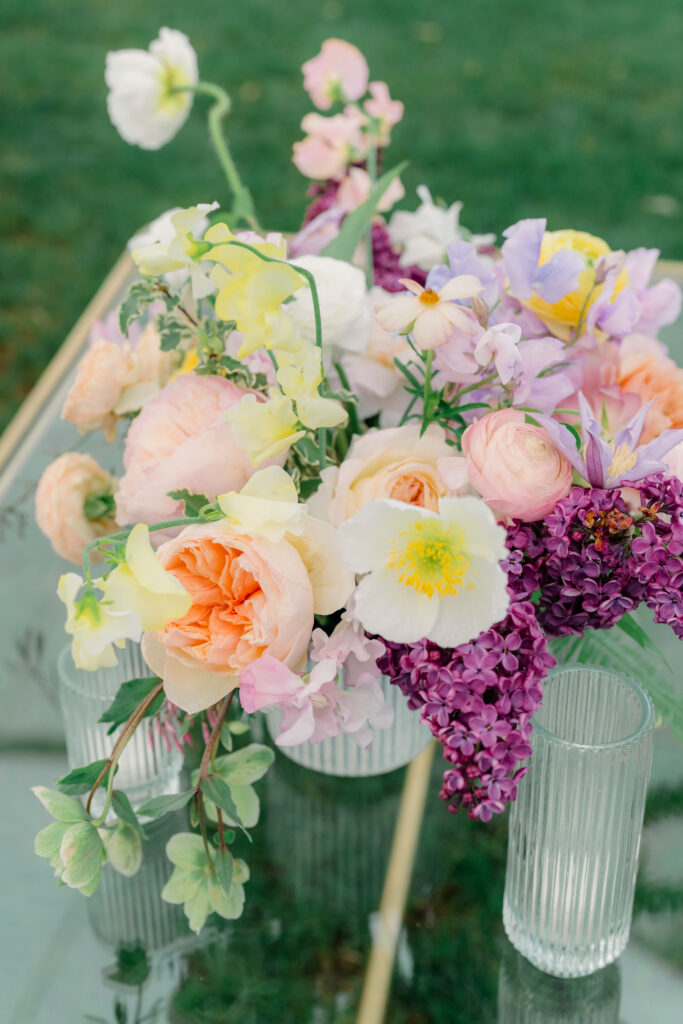 Pink, orange, yellow and purple wedding reception flowers. The florist bride had an absolute dream wedding on Spring Island in South Carolina. 