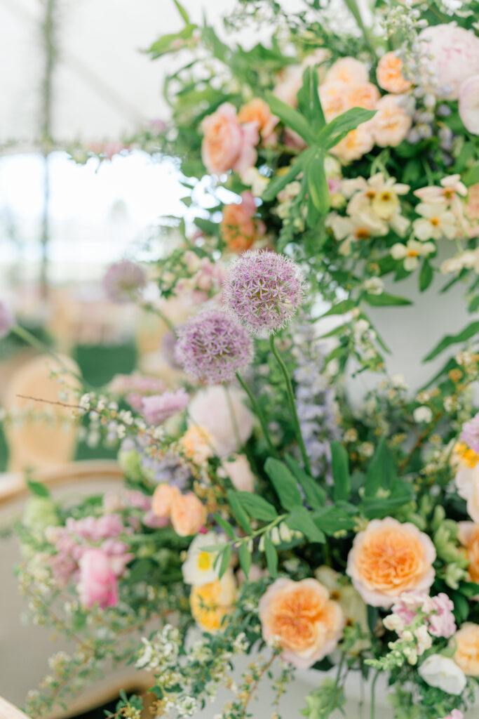 Flower details. Purple, orange and green. Outdoor wedding reception. 