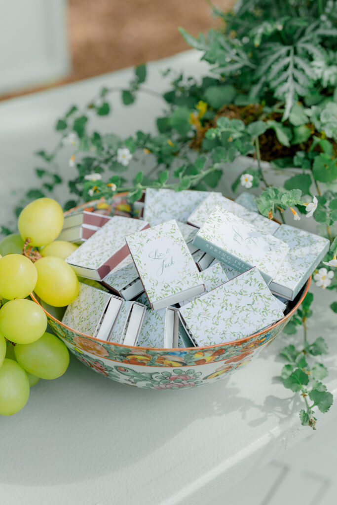 Custom green and white matchbooks with bride and grooms name and vine design. 