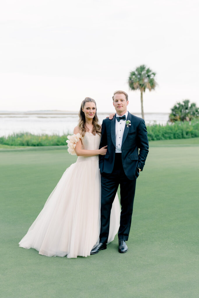 Bride and groom portrait with palm tree in background. 