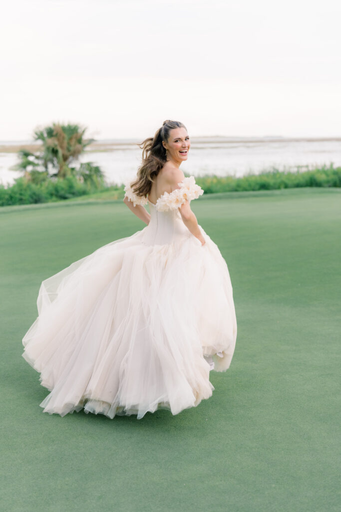 Runaway bride. Bride in blush pink dress on greenery with statement floral sleeves. 