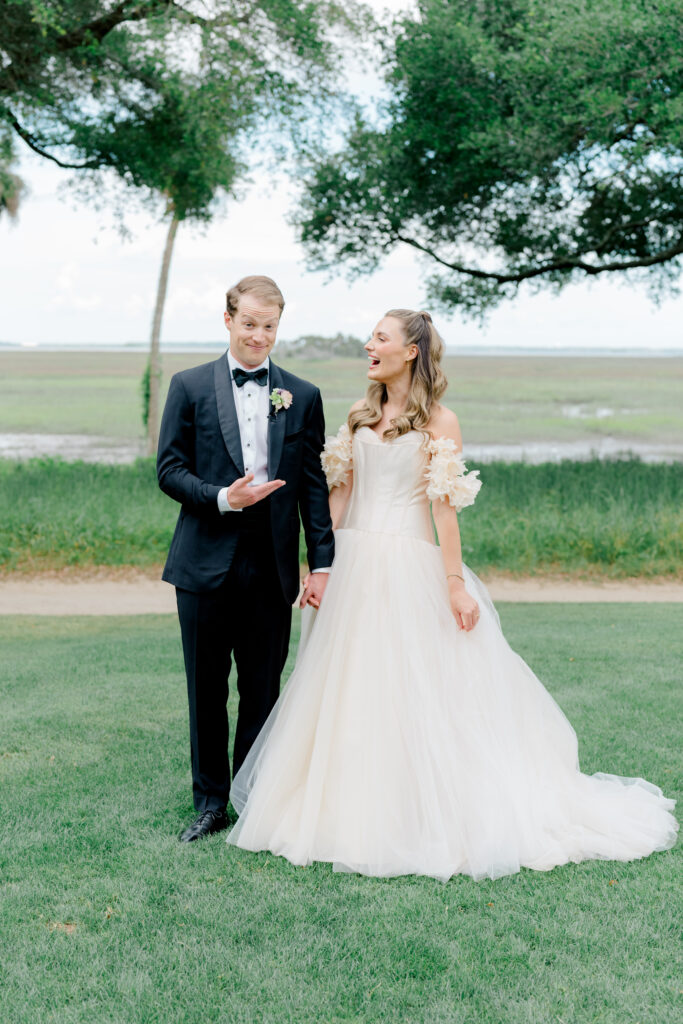 Groom is impressed by first look with bride. Bride wearing statement wedding dress. 