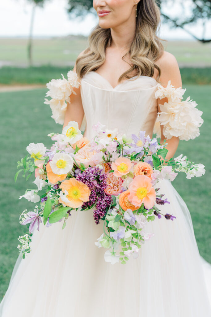 Asymmetrical over-flowing bride flowers with purple, peach and white. Spring Island Destination wedding. 