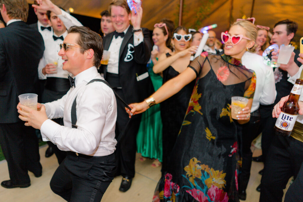 Candid dance floor flash photo of wedding guests. 