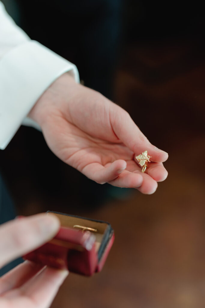 This florist bride incorporated hidden bees throughout her wedding including on the groom's cufflinks. 