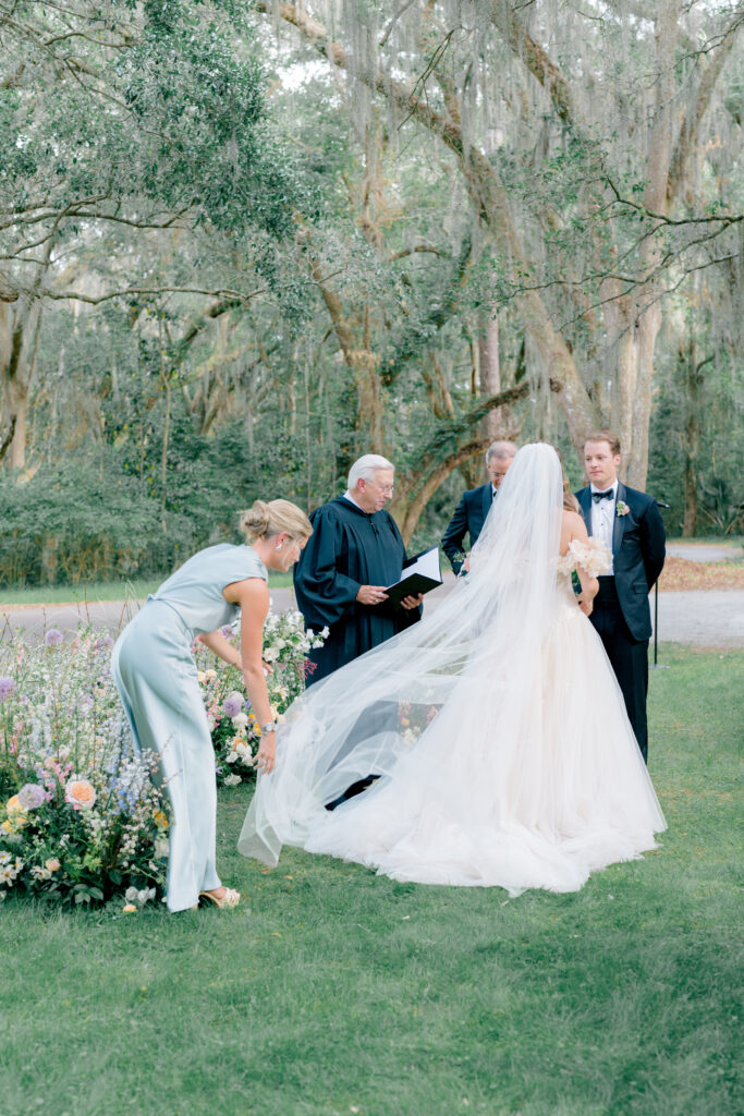 Maid of honor fixes brides veil. 