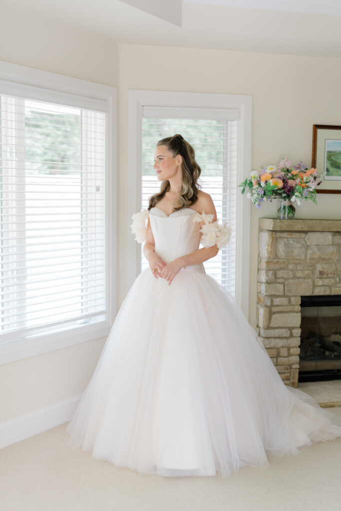 Bride puts on wedding dress for the first time. 