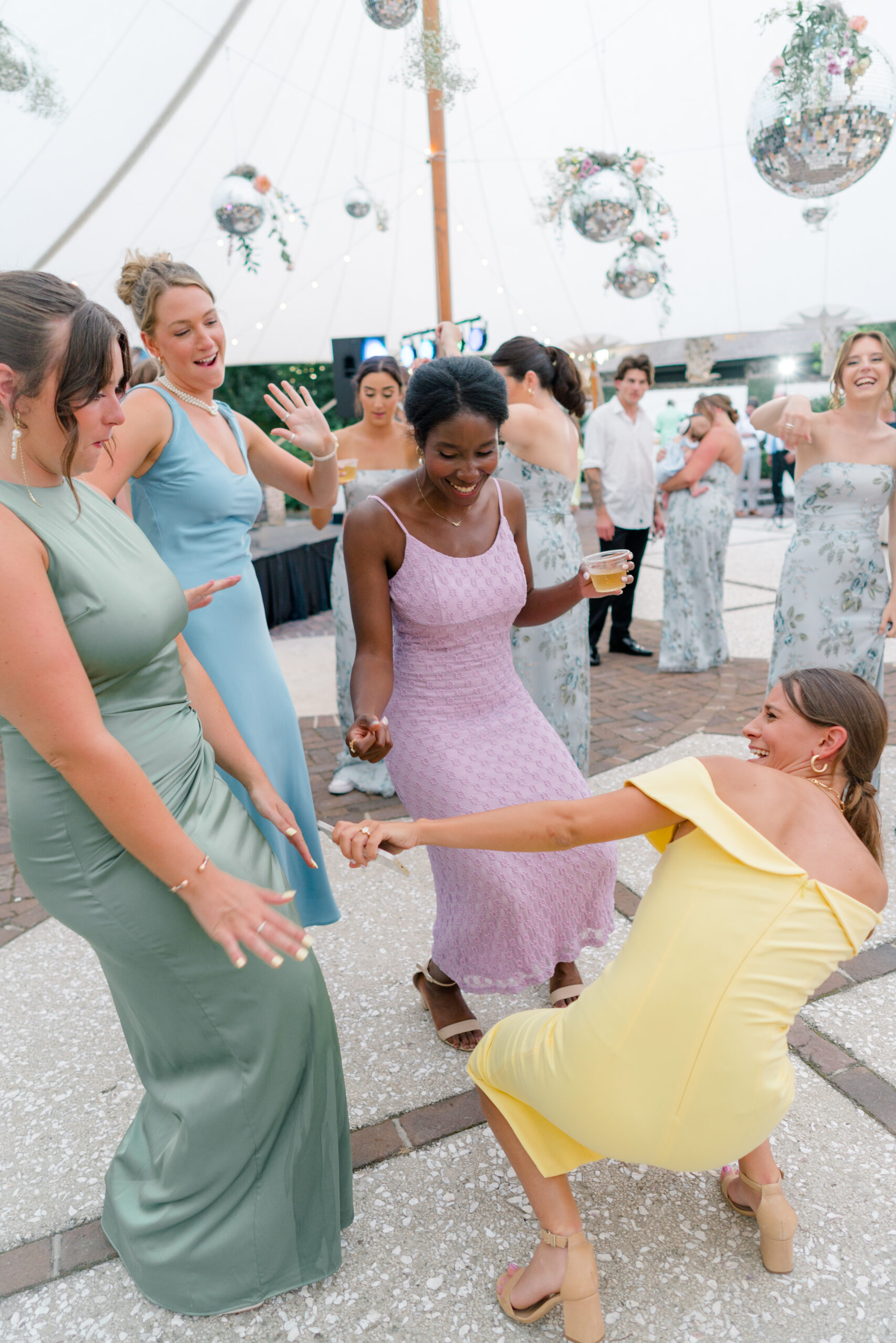 These wedding guests coordinated light pastel spring dress colors. Wedding guest coordinating outfit ideas. 