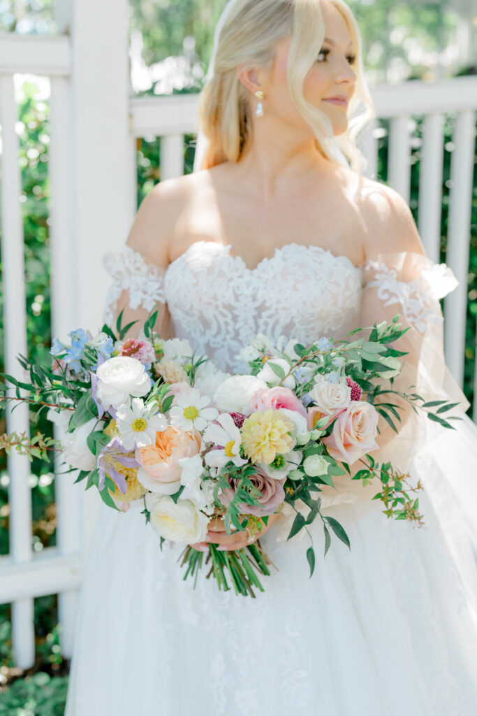 Mix-matched spring blooms made this bride's bouquet an absolute must see. Bride looking over left shoulder. 