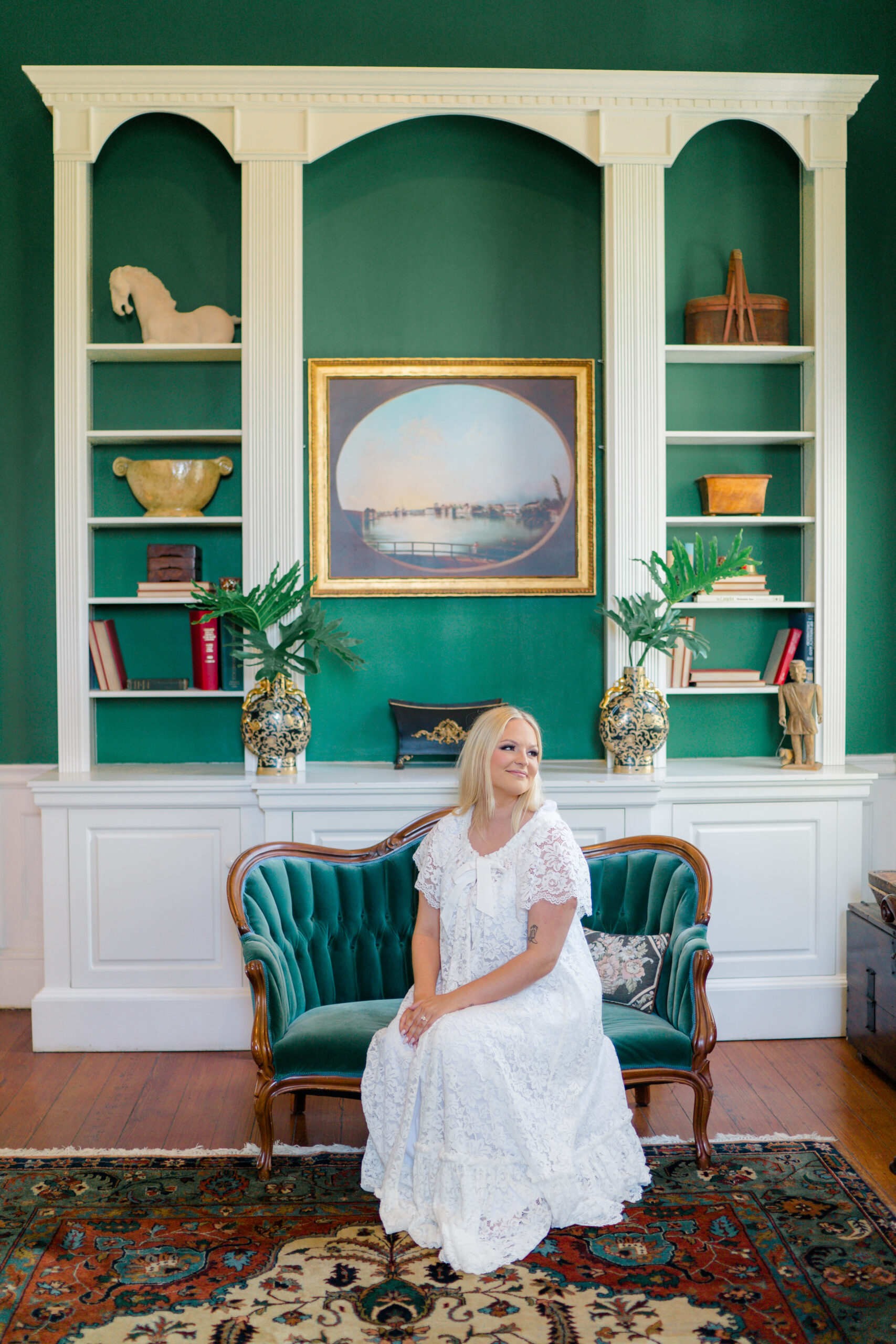 Bride sitting on couch in the green room at Thomas Bennett House. 