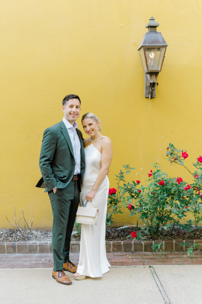 Classic Charleston portrait in front of yellow wall with gas lantern. 