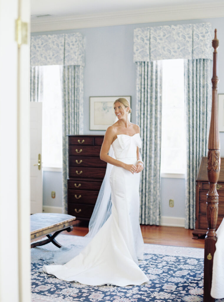 Bride puts on her dress during wedding day. Getting ready upstairs at Agapae Oaks. 