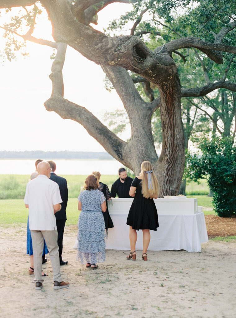 Dinner is served under live oak trees. 