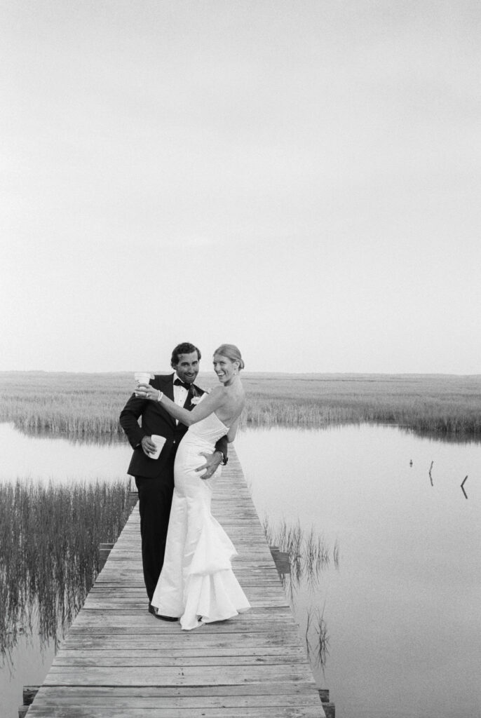 35mm film photo of bride and groom on dock. 