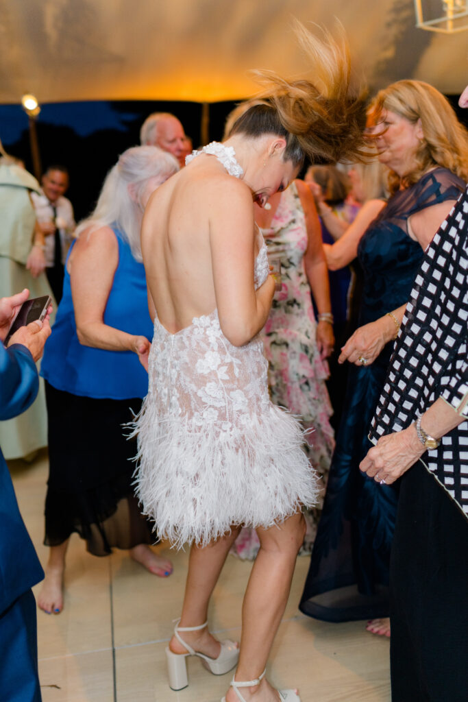 This bride changed into a high-necked lace fringe second dress and a party pony tail. 