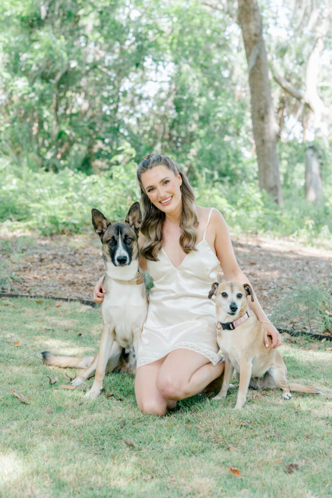 Bride in her pajamas with her dogs. 