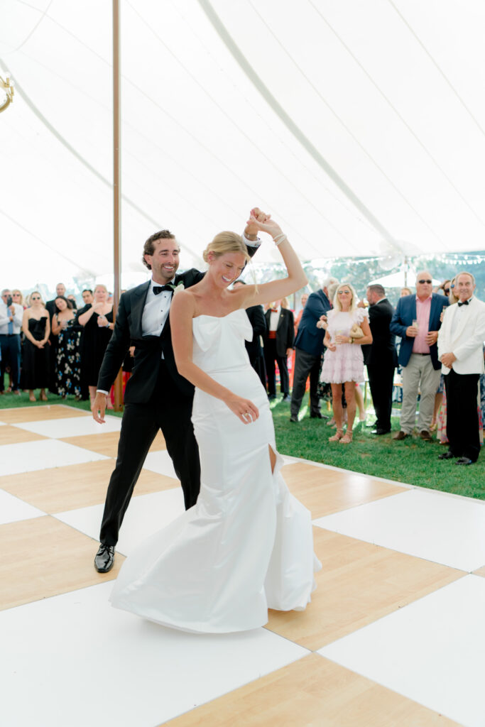 Bride and groom first dance under the tent at outdoor wedding reception. Agapae Oaks weddings. 