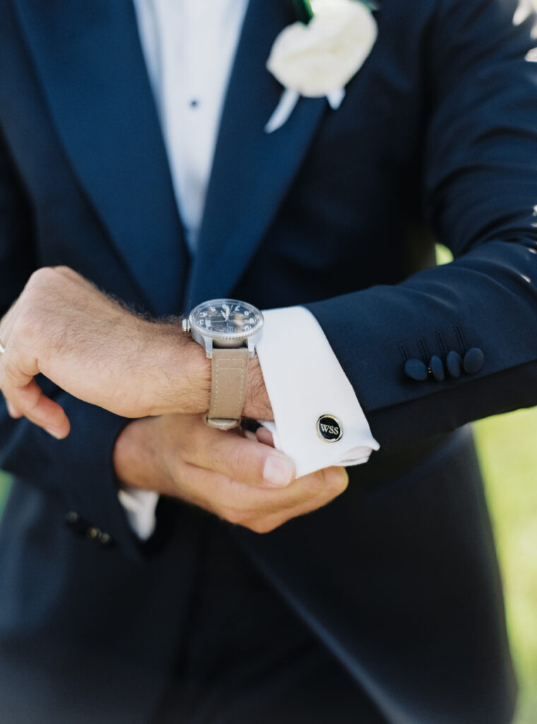 Groom shows off custom cufflinks. 