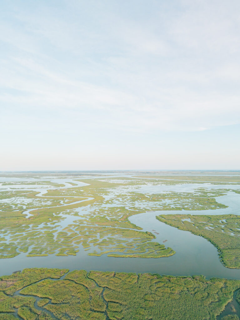 Drone photo of lowcountry marsh during sunset at Agapae Oaks wedding. 