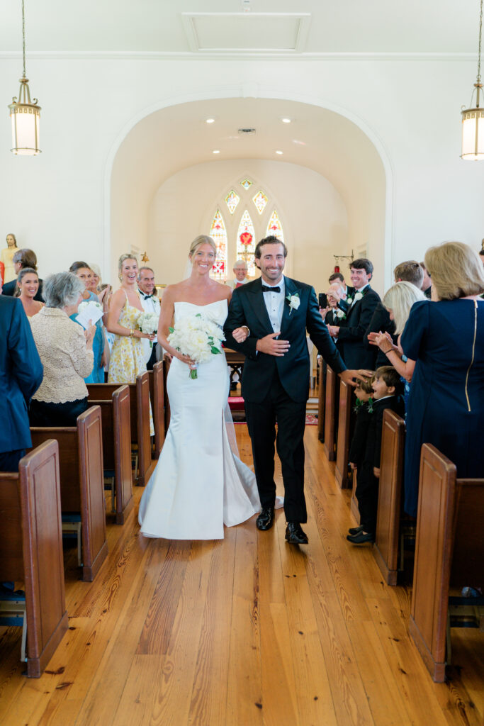 Bride and groom walk down the aisle during intimate wedding ceremony in downtown Beaufort. 