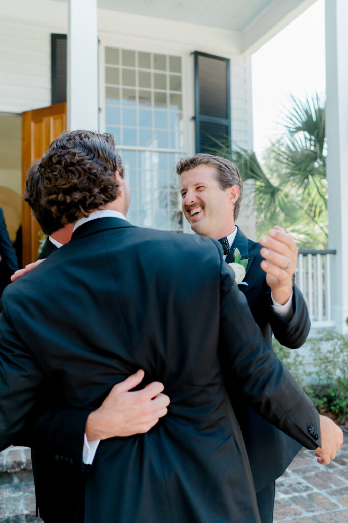 Groomsmen congratulate groom immediately after wedding ceremony. 