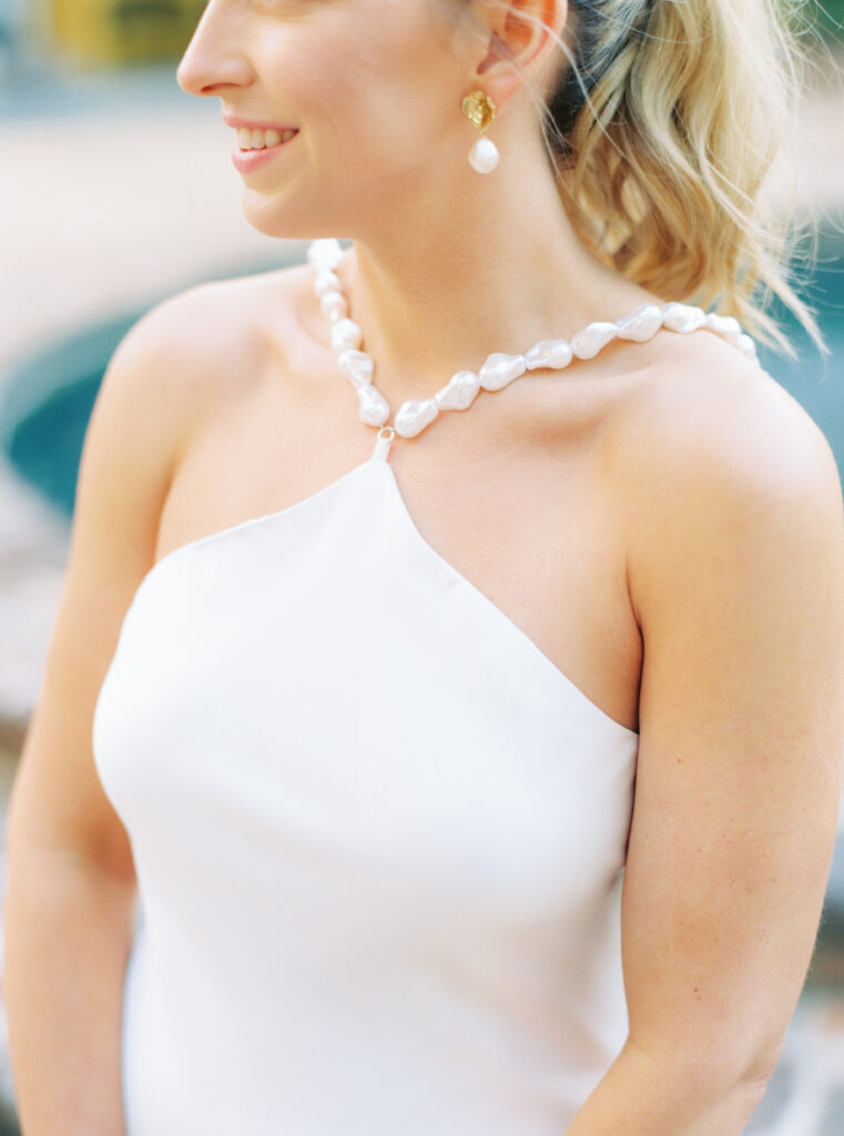 White halter top neckline dress with complementing earrings. 