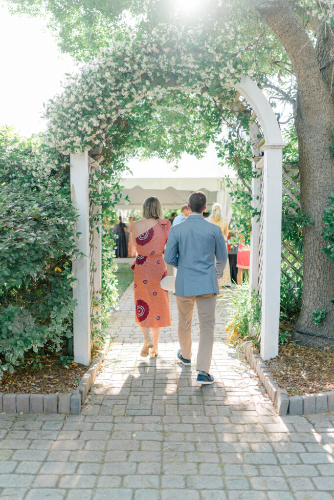 Rehearsal dinner guests enter through jasmine covered arch at the Beaufort Inn. 