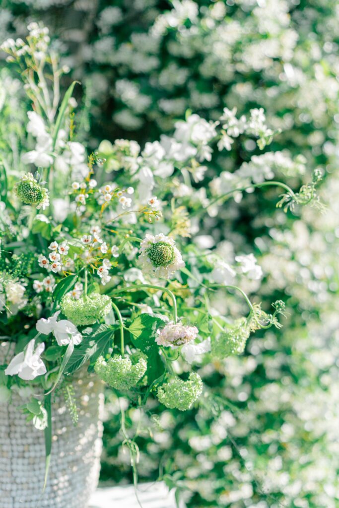 Whimsical non-traditional white and green wedding rehearsal dinner flowers. 