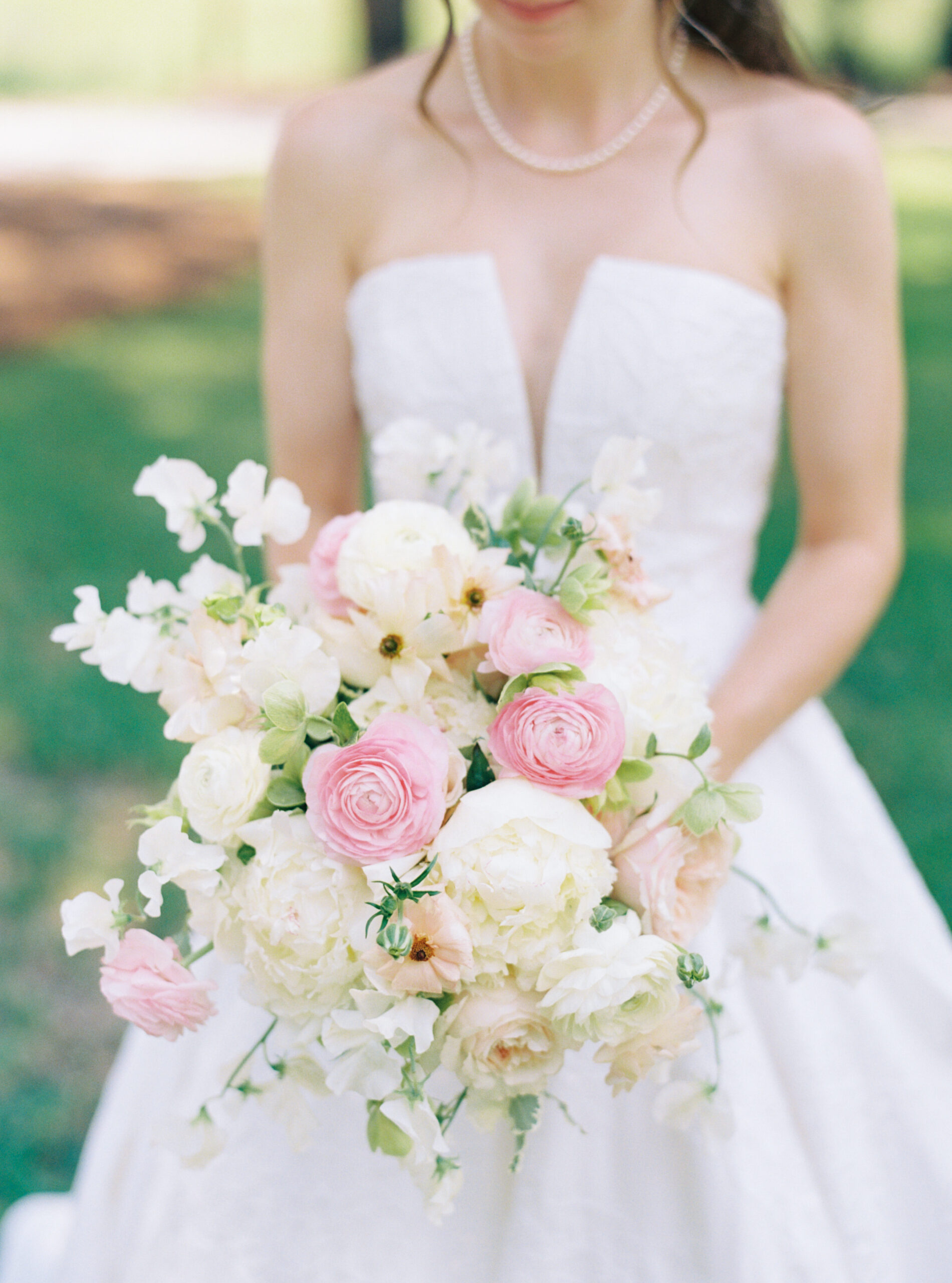 White and green bridal flowers with touches of pink. 