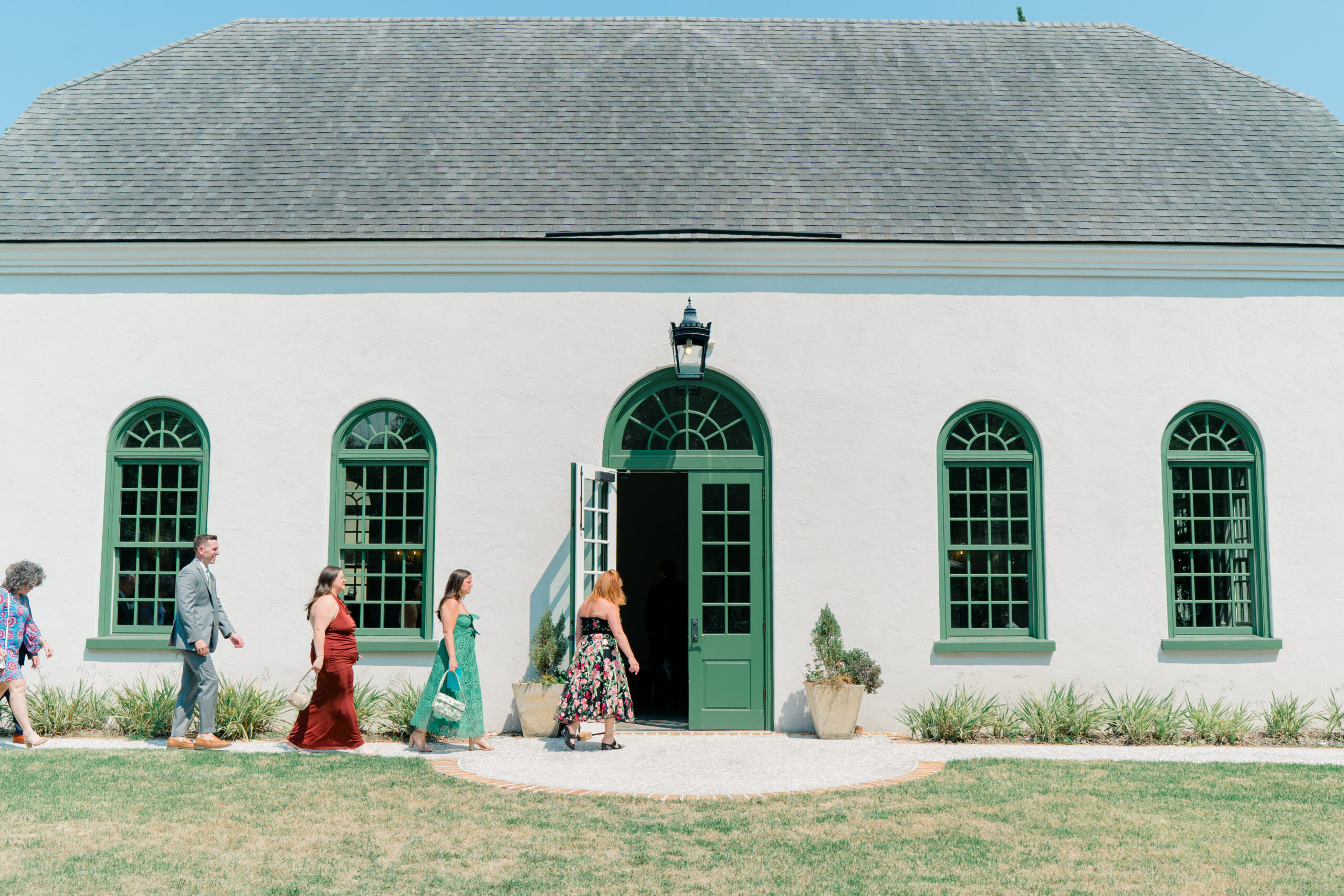 Wedding guests arrive to ceremony at the chapel at Ion