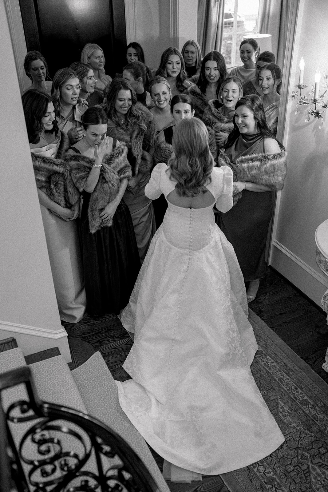 bridesmaids see bride in her wedding dress for the first time.