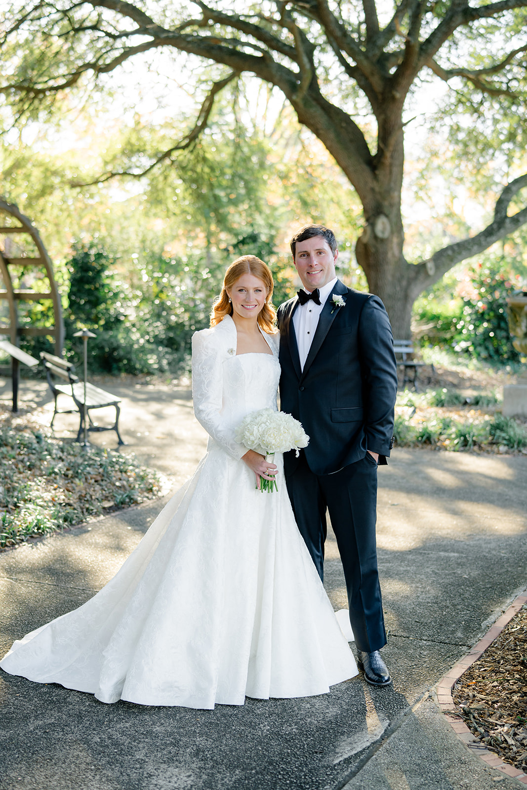 Bride and groom portrait on wedding day. Arch in back ground with bright light.