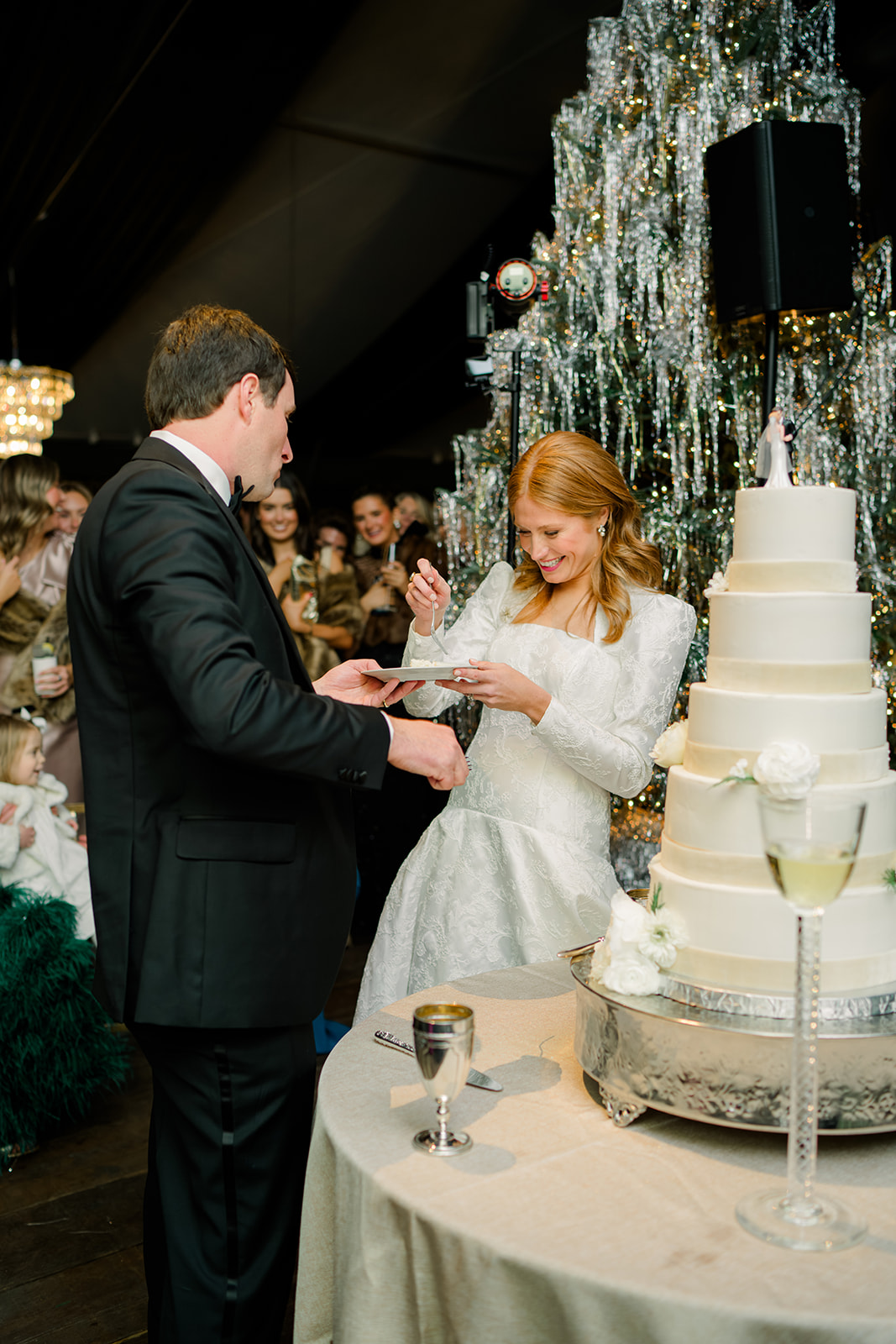 Bride and groom enjoy wedding cake. 5 tier wedding cake. 