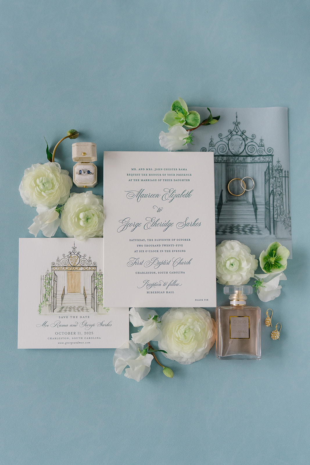 blue and white wedding details. paper goods. invitation suite with opaque sleeve with gate design. perfume bottle