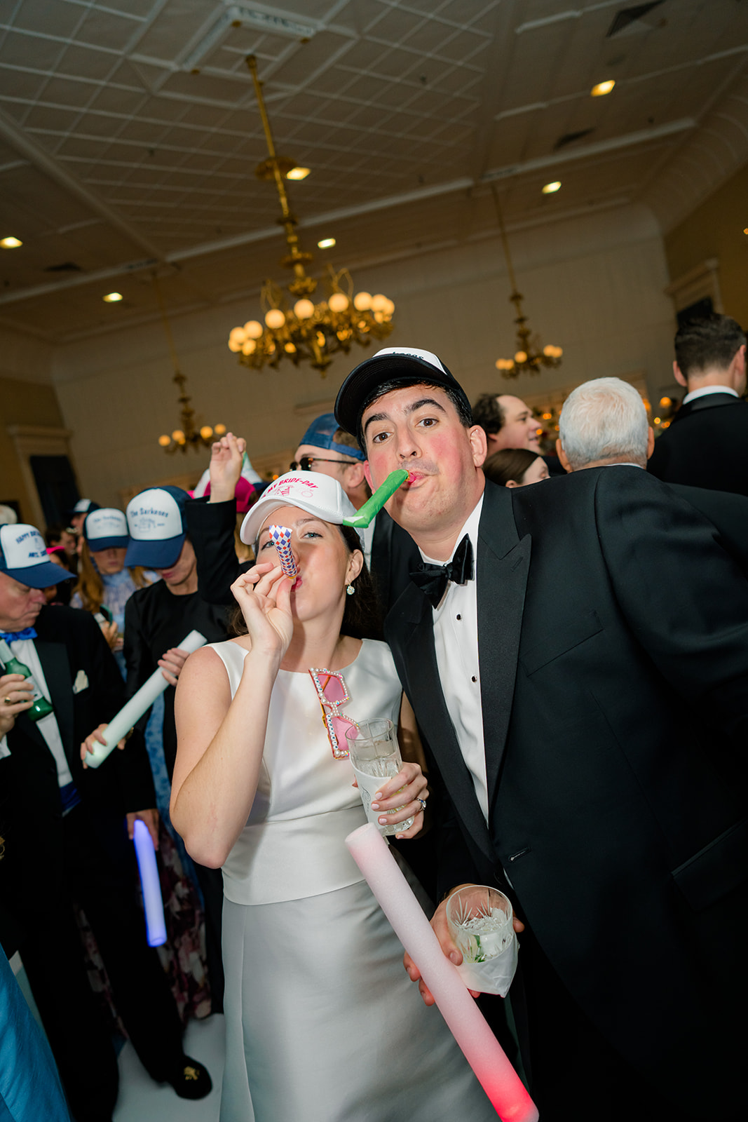 Bride and groom blow streamers on the dance floor for brides birthday. 